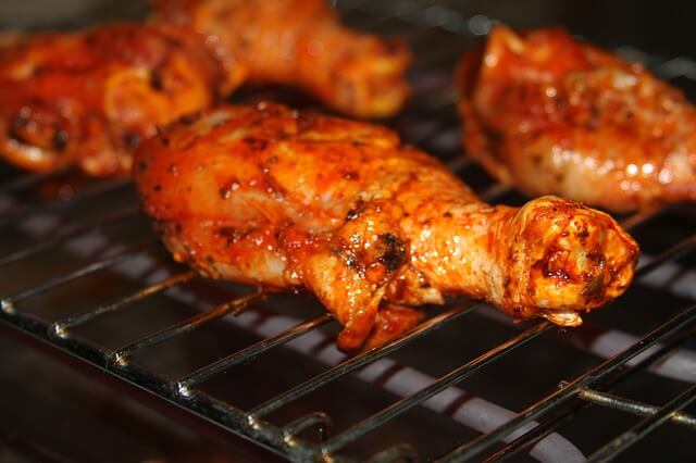Image of chicken thighs roasting on a grill